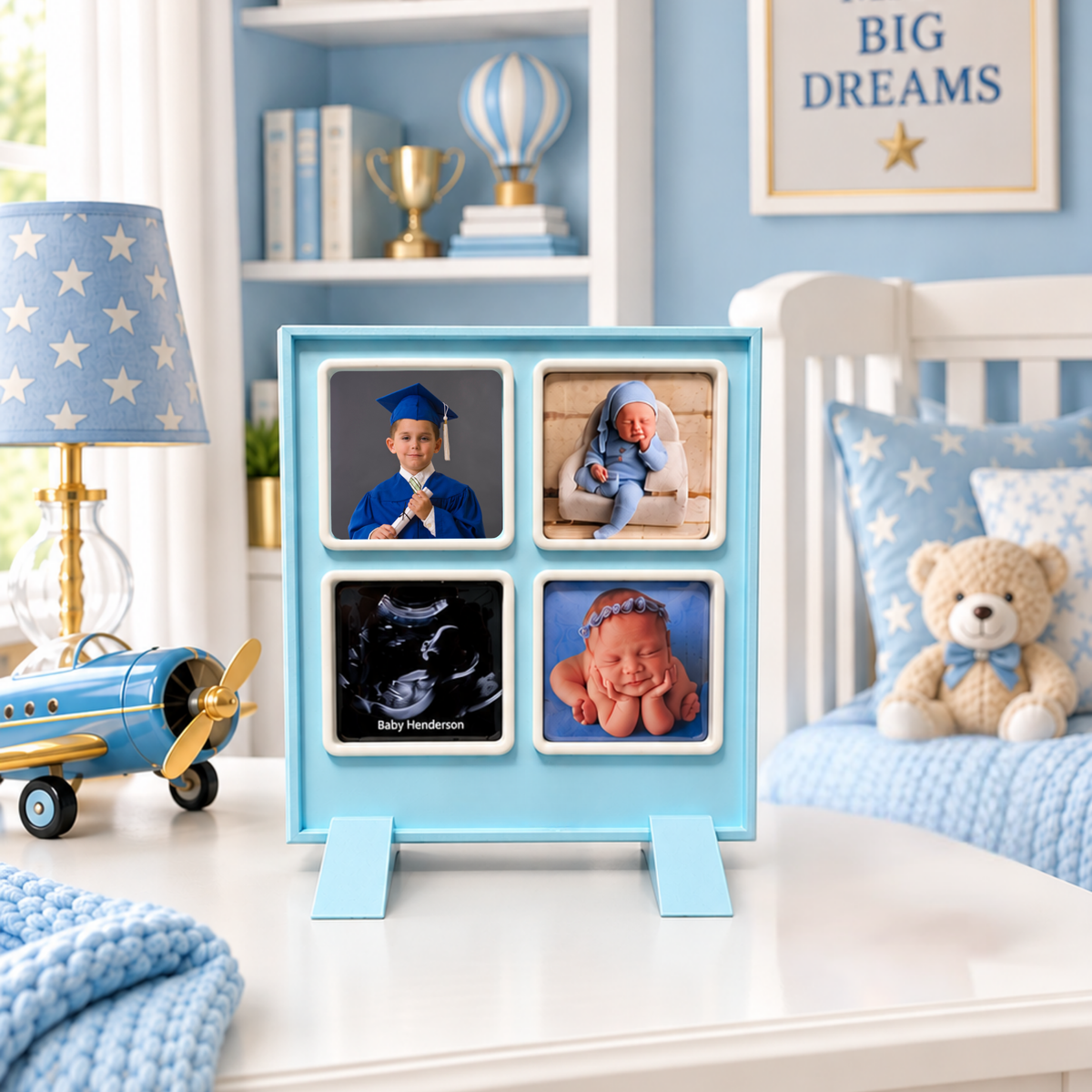 A light blue 4-photo magnet frame showing family photos, displayed on a white dresser in a styled nursery with blue bedding, a teddy bear, and a blue star lamp.