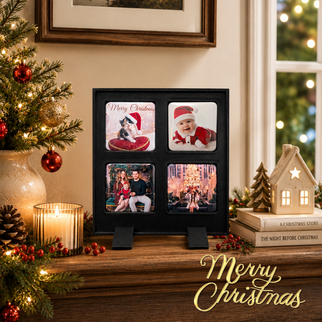 A black four-photo Christmas picture frame displayed on a wooden shelf in a decorated holiday setting, with a lit candle, pinecones, a small Christmas tree, books, and a house-shaped ornament nearby. The photos inside show festive holiday scenes and people.