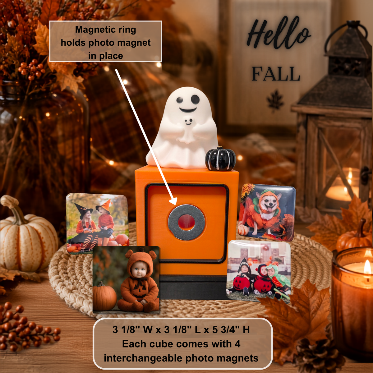 A Halloween-themed photo display featuring a mommy and baby white ghost on an orange cube and black base, with several square photo magnets arranged around it. Text overlays explain that the magnetic ring holds the photo magnet in place and note the dimensions and interchangeable photo feature.