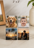 Four 2 x 2 photo magnets showing a dog, a smiling baby, a palm-tree sunset, and a couple at sunset.