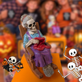 A Halloween memory cube with a skeleton woman sitting in a rocking chair and knitting a red sweater, displayed on an orange cube with a blurred festive background and cartoon skeleton graphics at the bottom corners.
