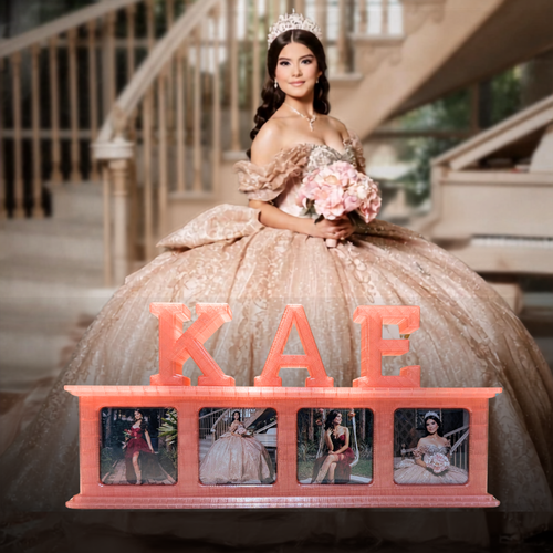 A woman in an elaborate champagne ball gown with a tiara standing in front of a staircase, holding a bouquet of pink flowers. In the foreground is a coral-pink customized photo frame spelling 'KAE' with four photo magnets showing her in different outfits.