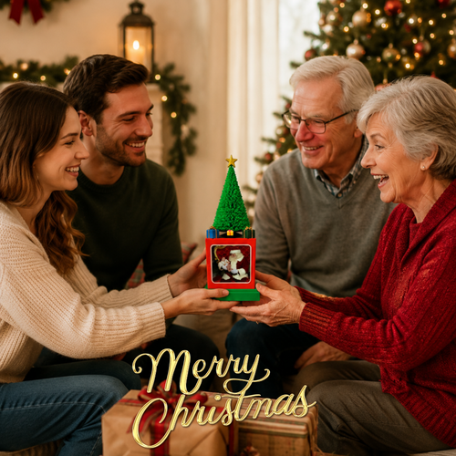 A family of four gathered in a warmly lit living room, smiling as they hold a small matte green Christmas tree with a red frame and a photo inside. The scene is decorated with holiday lights and garlands, and the words 'Merry Christmas' appear at the bottom.