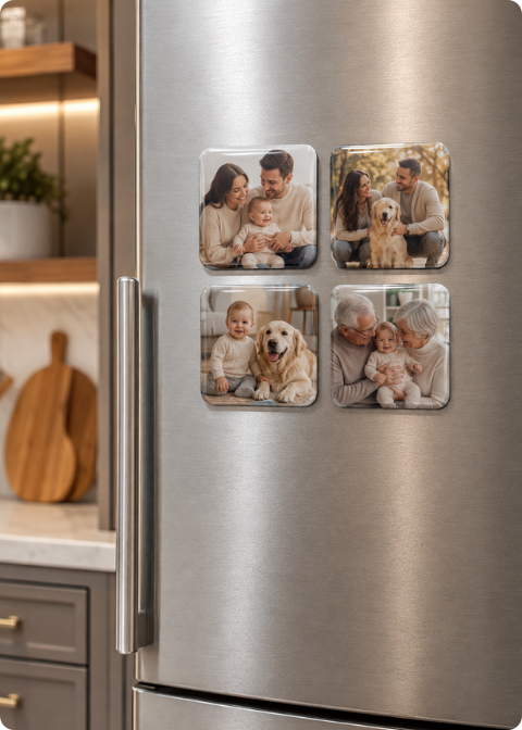 Four square photo magnets with rounded corners displaying family photos on a refrigerator door.