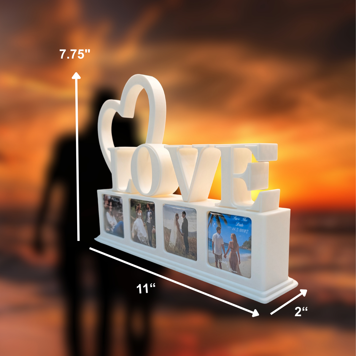 White photo frame sign spelling LOVE with a heart and four photo magnets, shown with dimension arrows and labels on a blurred sunset background.